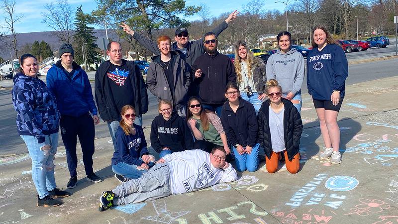 We Are Friends members Chalk the Walk at Penn State Altoona.